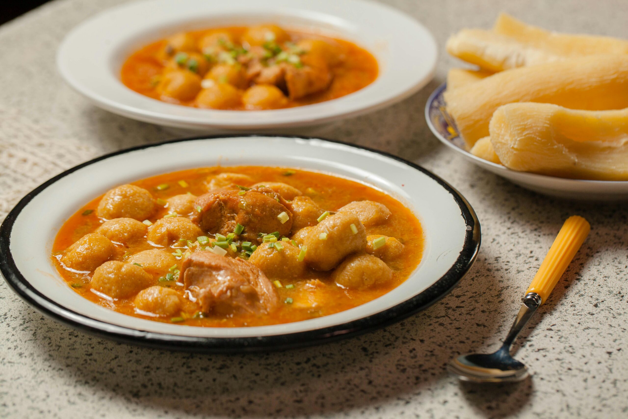 Delicious homemade Paraguayan chicken soup with cassava dumplings served on a rustic table.